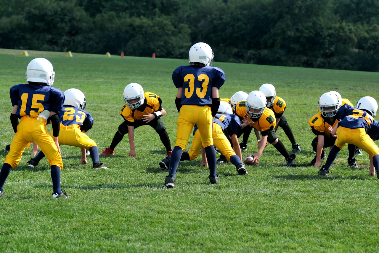 Youth football players lined up at the line of scrimmage